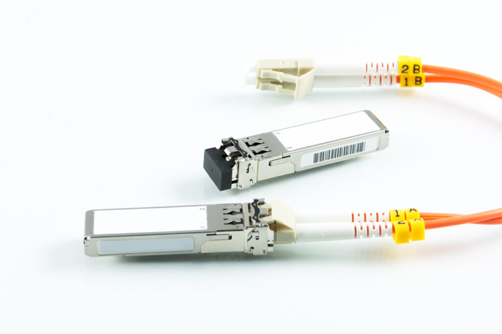 Fiber cable plugged into a silver optical engine